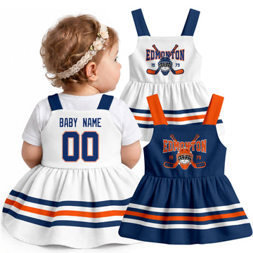 Personalized Edmonton hockey baby suspender dress shown on baby with Royal and White city-color styles