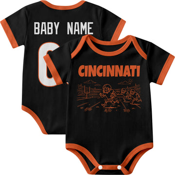 Cincinnati personalized baby football bodysuit in Black showing front field action scene and back custom baby name and number