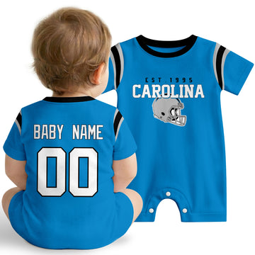 Baby wearing Carolina football-inspired personalized romper in blue, featuring custom name and number design with sporty varsity lettering and football helmet graphic