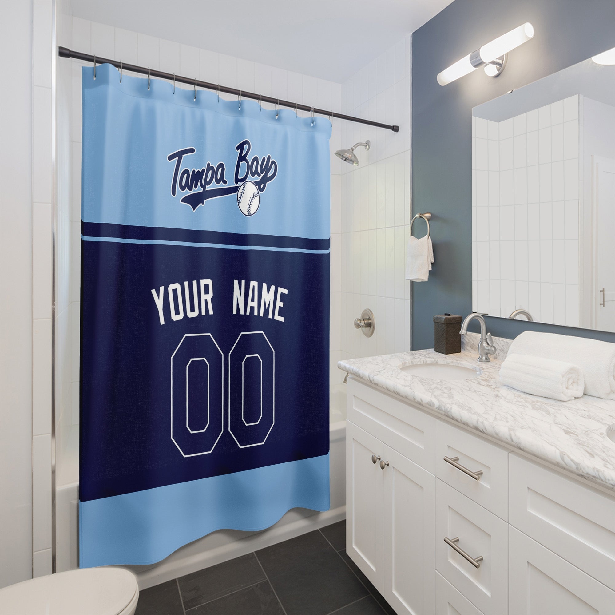 Personalized Tampa Bay baseball shower curtain in light blue navy and white hanging in a modern bathroom with custom name and number