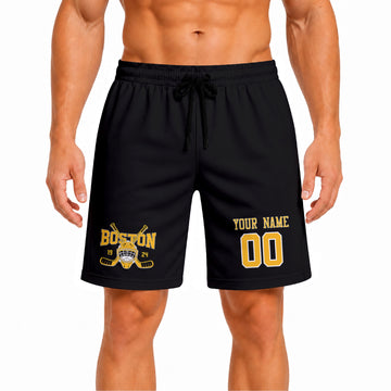 Black Boston-inspired hockey athletic shorts front view worn by male model, showcasing custom name, number, and team graphic