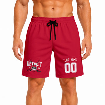 Red Detroit-inspired hockey athletic shorts front view worn by male model, showcasing custom name, number, and team graphic