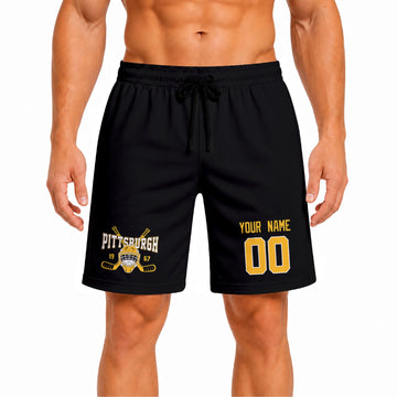 Black Pittsburgh-inspired hockey athletic shorts front view worn by male model, showcasing custom name, number, and team graphic